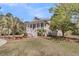 Attractive home with a classic front porch, white railings, and well-kept landscaping adding to its curb appeal at 4051 Colonel Vanderhorst Cir, Mount Pleasant, SC 29466