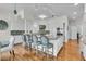 Spacious kitchen featuring an island with seating, white cabinetry, stainless appliances, and hardwood floors at 4051 Colonel Vanderhorst Cir, Mount Pleasant, SC 29466