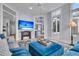 Open concept living room showcasing a blue ottoman, large television, and easy access to other parts of the home at 4051 Colonel Vanderhorst Cir, Mount Pleasant, SC 29466