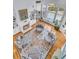 Aerial view of a spacious living room with a fireplace, large windows, and four round chairs at 4051 Colonel Vanderhorst Cir, Mount Pleasant, SC 29466