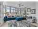 Comfortable living room with a plush blue sectional, patterned rug, and expansive windows overlooking lush greenery at 4051 Colonel Vanderhorst Cir, Mount Pleasant, SC 29466