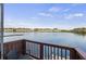 View from a beautiful private balcony overlooking a serene body of water and waterfront homes at 4789 Arco Ln, North Charleston, SC 29418