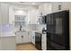 Updated kitchen with black appliances, modern white cabinetry and subway tile backsplash at 4789 Arco Ln, North Charleston, SC 29418