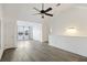Open-concept living area with vaulted ceilings, stylish gray floors, and water views at 4789 Arco Ln, North Charleston, SC 29418