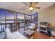 Relaxing screened-in porch with outdoor seating and grill; enjoy the beautiful lake views at 4789 Arco Ln, North Charleston, SC 29418