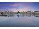 Waterfront view showcasing lakeside homes, a pier, and picturesque water fountain features at 4789 Arco Ln, North Charleston, SC 29418