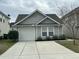 Beautiful single-Gathering home showcasing a driveway, garage, and manicured front yard at 4957 Trump St, North Charleston, SC 29420