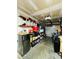 Organized garage with shelving units, overhead storage, and a convenient mini-refrigerator at 4957 Trump St, North Charleston, SC 29420