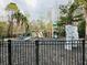 Community playground with climbing wall, slides, and play structures, surrounded by a secure fence at 4957 Trump St, North Charleston, SC 29420