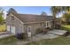Rear view of a brick house with an attached garage and backyard with patio at 5330 Waterview Dr, North Charleston, SC 29418