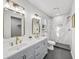 Bright bathroom featuring double sinks, and a marble-tiled shower in a modern, clean design at 5330 Waterview Dr, North Charleston, SC 29418
