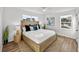 Bright and inviting bedroom featuring a large bed, wood floors, ample natural light, and stylish decor at 5330 Waterview Dr, North Charleston, SC 29418