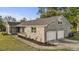View of a brick home with attached garage, and a well-manicured lawn at 5330 Waterview Dr, North Charleston, SC 29418