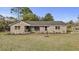 Charming brick home with a well-manicured lawn and mature trees against a clear blue sky at 5330 Waterview Dr, North Charleston, SC 29418