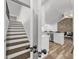 Bright interior view featuring a staircase and an open-concept kitchen, showcasing modern design elements at 5330 Waterview Dr, North Charleston, SC 29418