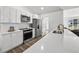 Well-lit kitchen featuring white cabinets, stainless steel appliances, and a modern backsplash at 5330 Waterview Dr, North Charleston, SC 29418