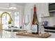 Elegant kitchen detail featuring a golden faucet and a decorative wine bottle on a white countertop at 5330 Waterview Dr, North Charleston, SC 29418