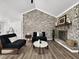 Stylish living room with brick accent wall, fireplace, and modern furnishings on hardwood floors at 5330 Waterview Dr, North Charleston, SC 29418