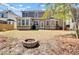 Spacious backyard featuring a fire pit and a well-maintained lawn at 5409 Clairmont Ln, North Charleston, SC 29420
