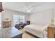 Bright bedroom with desk, bookshelves and a bed beside a window and ceiling fan at 5409 Clairmont Ln, North Charleston, SC 29420