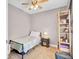 Cozy bedroom with a twin bed, nightstand, and ceiling fan at 5409 Clairmont Ln, North Charleston, SC 29420