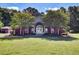 Welcoming clubhouse with manicured lawns and mature trees at 5409 Clairmont Ln, North Charleston, SC 29420