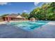 Large community pool with plenty of seating and umbrellas for lounging at 5409 Clairmont Ln, North Charleston, SC 29420