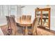 Formal dining room with an oval table, six upholstered chairs, and a vintage cabinet with dishware at 5409 Clairmont Ln, North Charleston, SC 29420