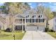 Charming two-story home with a well-manicured lawn, three dormer windows, and a wide driveway leading to a two-car garage at 5409 Clairmont Ln, North Charleston, SC 29420
