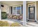 Inviting front porch featuring rocking chairs and a welcoming entrance with a black door and decorative sidelight at 5409 Clairmont Ln, North Charleston, SC 29420