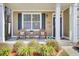 Charming front porch with rocking chairs and manicured landscaping at 5409 Clairmont Ln, North Charleston, SC 29420