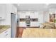 Modern kitchen showcasing stainless steel appliances, white cabinetry, and granite countertops at 5409 Clairmont Ln, North Charleston, SC 29420