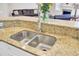Close up on the kitchen island featuring stainless steel sinks and granite countertops at 5409 Clairmont Ln, North Charleston, SC 29420