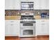 Close up on a stainless steel range, oven, and microwave in a modern white kitchen at 5409 Clairmont Ln, North Charleston, SC 29420