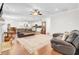 Spacious living room featuring hardwood floors, leather seating, and an open floor plan at 5409 Clairmont Ln, North Charleston, SC 29420