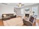 Comfortable living room featuring hardwood floors, a fireplace, and plush leather seating with ample natural light at 5409 Clairmont Ln, North Charleston, SC 29420