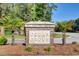 Community sign for Cedar Grove nestled among well manicured landscape at 5409 Clairmont Ln, North Charleston, SC 29420