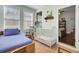 sunroom with chair, rocker, and baby bed, with a view into the main bedroom at 5409 Clairmont Ln, North Charleston, SC 29420