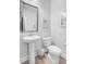 Bathroom with pedestal sink, white toilet, framed mirror, neutral paint, and minimalist decor at 5415 Clairmont Ln, North Charleston, SC 29420