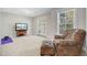 Bright bonus room with plush chair, TV, and french doors to a porch at 5415 Clairmont Ln, North Charleston, SC 29420