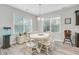 A bright dining room is furnished with a white table and chairs, and surrounded by natural light at 5415 Clairmont Ln, North Charleston, SC 29420