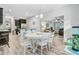 An open concept dining area is filled with natural light, complemented by the kitchen and living areas at 5415 Clairmont Ln, North Charleston, SC 29420