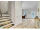 Entryway featuring a staircase, doorway into the living room, with light-colored walls and floors at 5415 Clairmont Ln, North Charleston, SC 29420