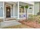 Inviting front porch with hanging flower baskets and decorative accents at 5415 Clairmont Ln, North Charleston, SC 29420
