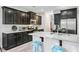 Kitchen with dark cabinets, stainless steel appliances, granite countertops, and blue barstools at 5415 Clairmont Ln, North Charleston, SC 29420