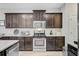 A kitchen with dark cabinets, stainless steel appliances, and light countertops offers a modern look at 5415 Clairmont Ln, North Charleston, SC 29420