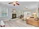 Cozy living room featuring a fireplace, hardwood floors, and abundant natural light at 5415 Clairmont Ln, North Charleston, SC 29420
