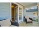 Charming outdoor seating area with comfortable wicker chairs and blue siding at 5415 Clairmont Ln, North Charleston, SC 29420
