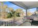 Covered porch boasts a view of the neighborhood with mature trees and pretty homes at 5415 Clairmont Ln, North Charleston, SC 29420