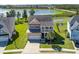 Aerial view of a landscaped home in a lakeside community with a private pond and outdoor seating at 543 Pendleton Dr, Moncks Corner, SC 29461